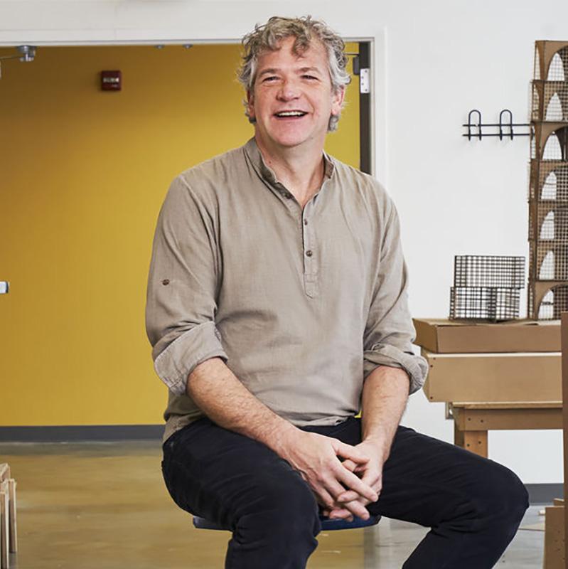 Stephen Anderson sitting on a stool inside Tyler, smiling warmly at the camera.