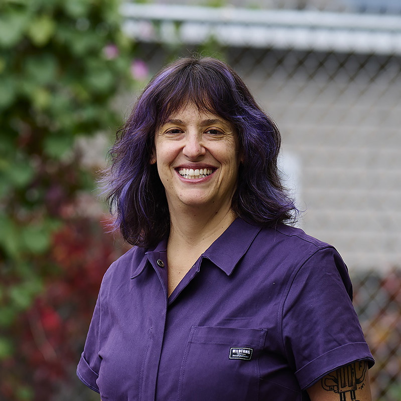 Abby Guido smiles at the camera, looking relaxed and confident.